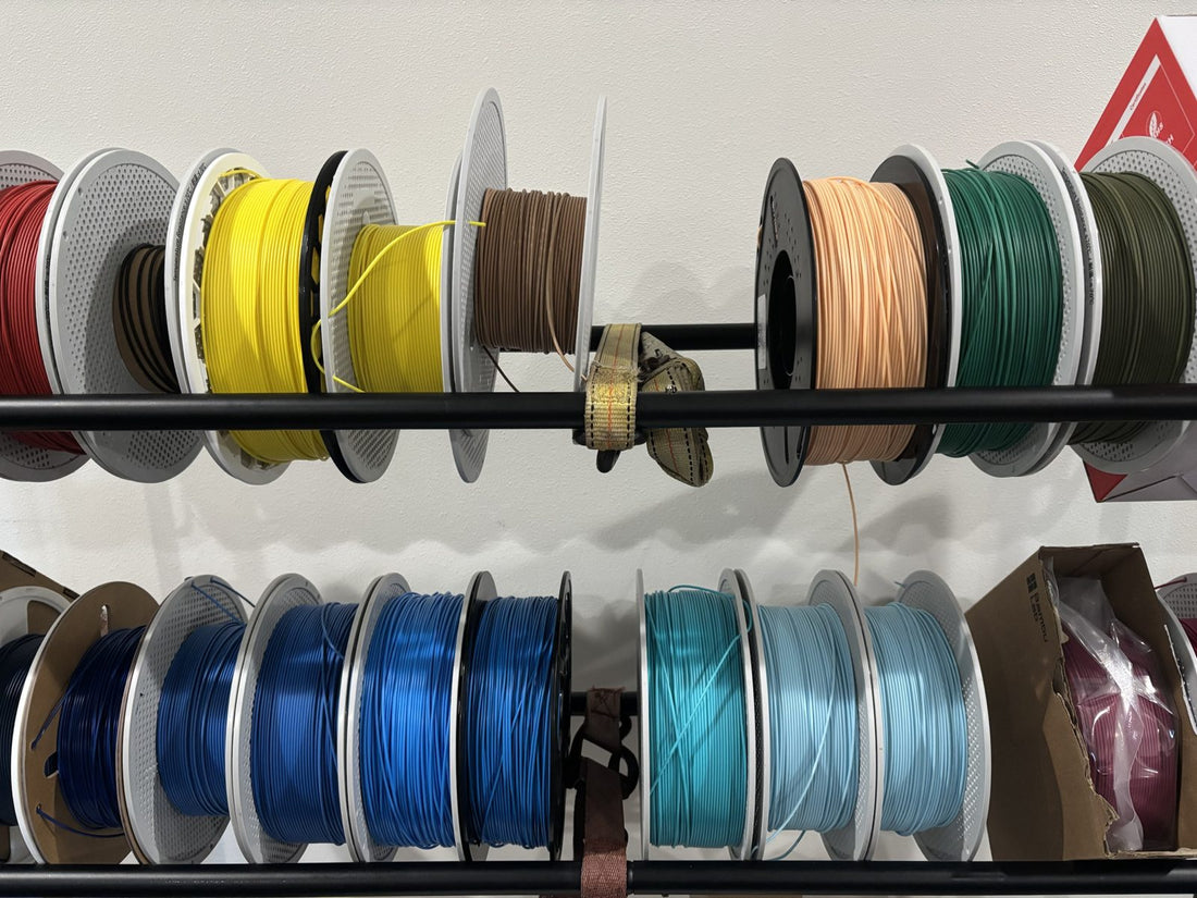 Wall of PLA and PETG filament spools in our Bremerton shop